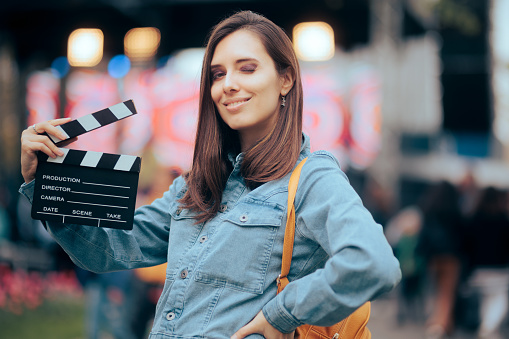 Video producer with clapperboard ready to shoot a scene