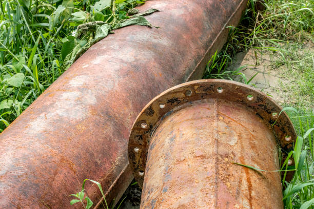 istock Close up shot of rustic dredging pipelines on a meadowland 1396591803