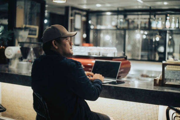 istock indian man sitting in cafe, working 1396591815