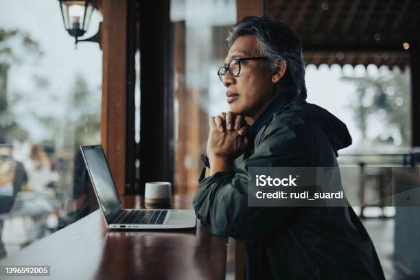 Businessman Sitting In Cafe Working Stock Photo - Download Image Now - Men, Indonesia, Portrait