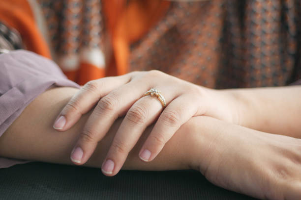 istock close up of women's hands with wedding ring 1396592686