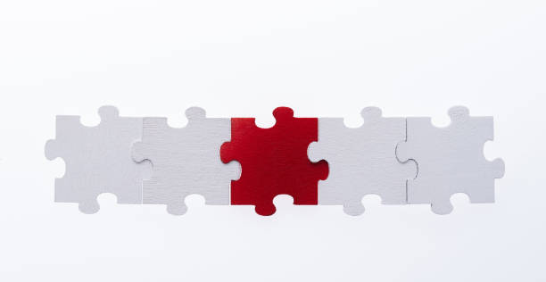 istock A row of jigsaw pieces on white background 1396595983