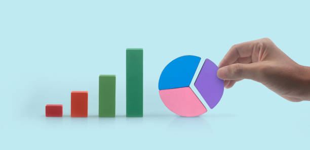istock Business connecting piece of multi colored pie chart in  hand 1396596346