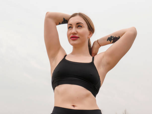 istock A young female athlete with an athletic figure poses on a sandy beach 1396597453