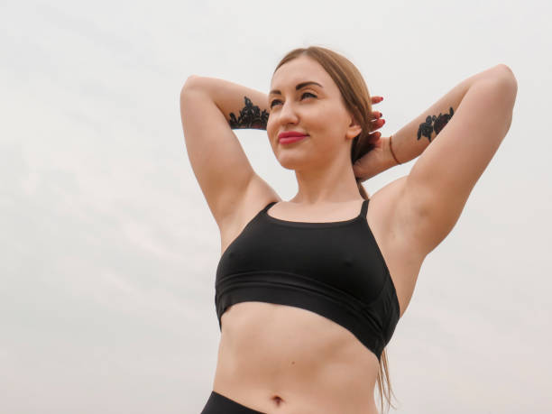 istock A young female athlete with an athletic figure poses on a sandy beach 1396598297