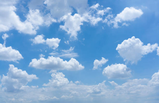 Upward view photo of beautiful white fluffy clouds on vivid blue sky in a sunny day stock photo
