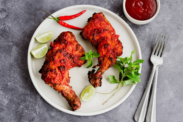 Roasted Whole Chicken Legs with Condiment Directly Above Photo Chicken Tandoori, Roast Chicken Legs, Rustic Indian Chicken Preparation Photo Top Down and Horizontal tandoori chicken stock pictures, royalty-free photos & images