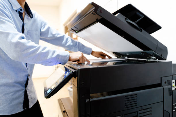 istock Bussiness man Hand press button on panel of printer, printer scanner laser in office copy machine supplies start concept. 1396605335
