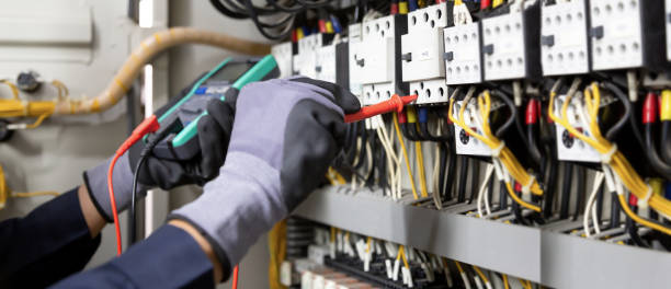 istock Electrician engineer tests electrical installations and wires on relay protection system. Adjustment of scheme of automation and control of electrical equipment. 1396605416