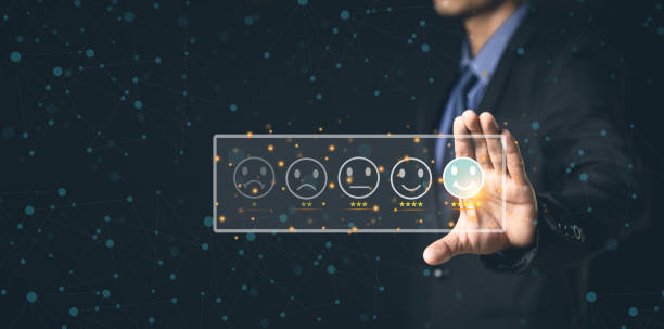 istock Customer Service and Satisfaction Concept Businessmen touch the virtual screen on happy smiley icons to achieve service satisfaction and feedback with excellent rated reviews. 1396605466