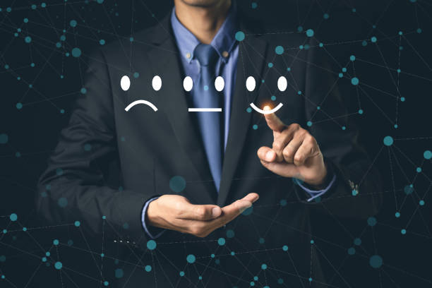 istock Customer Service and Satisfaction Concept Businessmen touch the virtual screen on happy smiley icons to achieve service satisfaction and feedback with excellent rated reviews. 1396605474