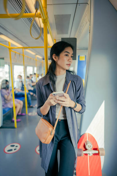 istock Asian working on smartphone in electric train. 1396606114