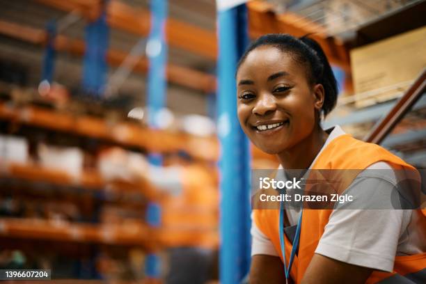 Happy Black Female Worker At Distribution Warehouse Looking At Camera Stock Photo - Download Image Now
