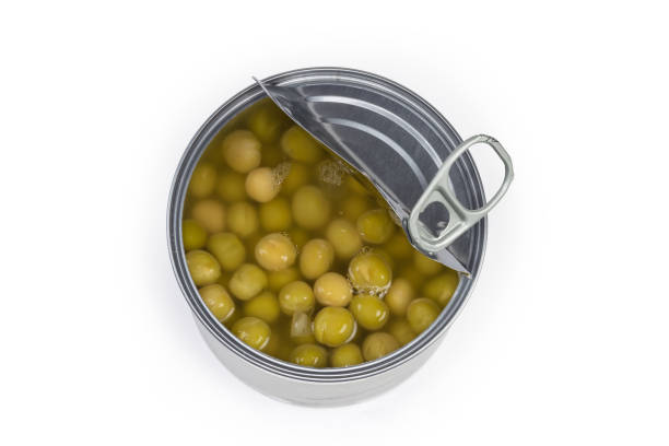 istock Open round tin can with canned green peas, top view 1396607254