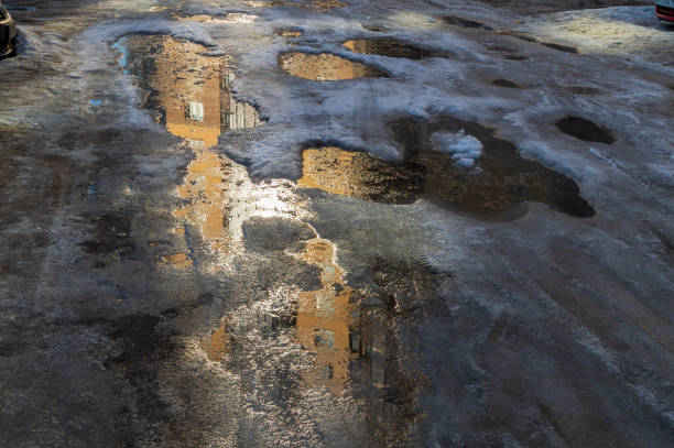 istock reflection of an apartment building in a muddy puddle. 1396607335