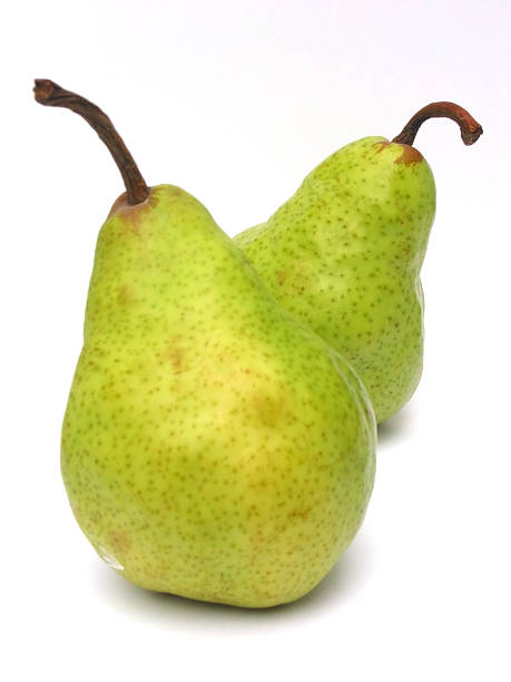 Pair of Pears Perfect pair of Bartlett pears, with focus on the back pear. Popular wedding theme, and also the Official State Fruit of Oregon. bartlett pear stock pictures, royalty-free photos & images