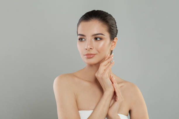 istock Stylish woman. Beautiful female face on grey background 1396609755