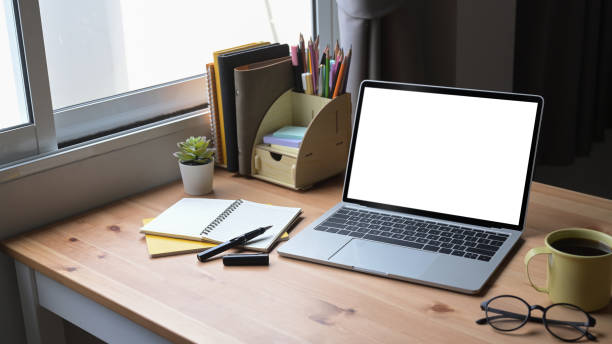 istock Mock up laptop computer, notebook, coffee cup and houseplant on wooden table. 1396611003