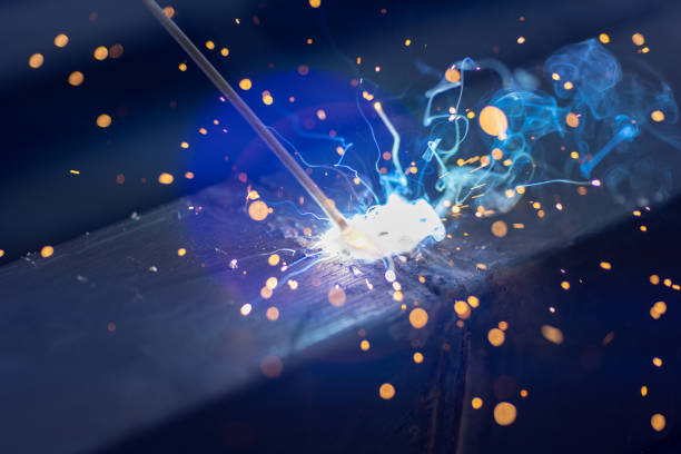 istock worker welding steel pipe in construction site.