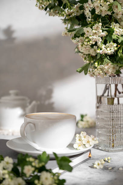 istock Cup coffee with milk and blooming tree brunches, stillife image 1396613344