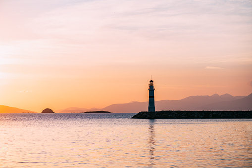 Aegean Coast and lighthouse at sunset