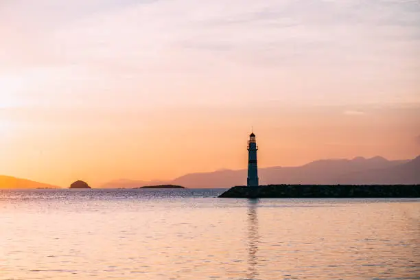 Photo of Aegean Coast and lighthouse at sunset