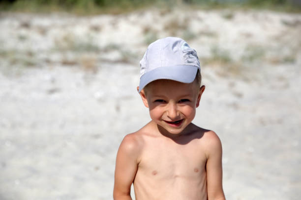 Cute smiling little boy on the sea beach
