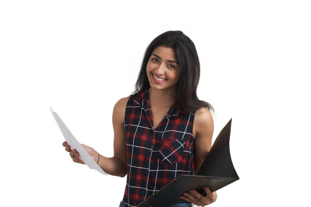 istock Young Venezuelan student smiling holding papers and folder, isolated. 1396615840