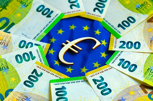state of the economy and currency of the EU countries. euro bills and the euro sign on the flag of the European Union.Depreciation of the euro currency.European economic market.