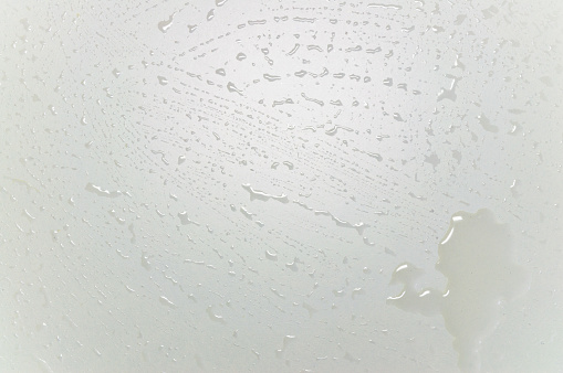 white table surface with drops on it