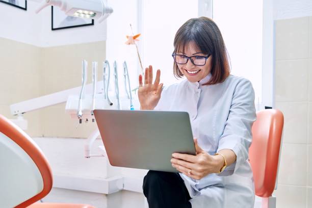 Online consultation, doctor help in clinic using laptop. stock photo