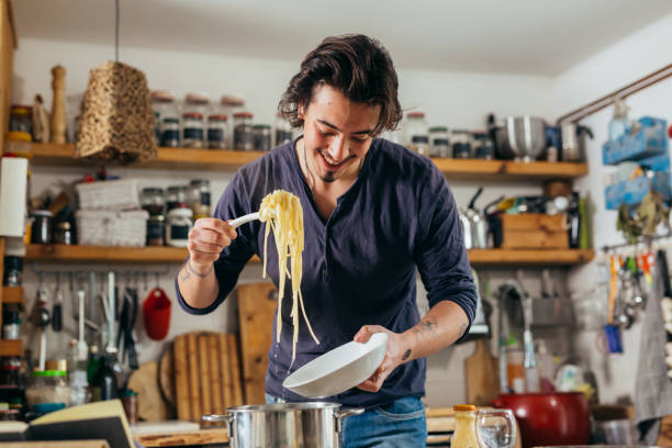 istock man preapars food at home 1396617272