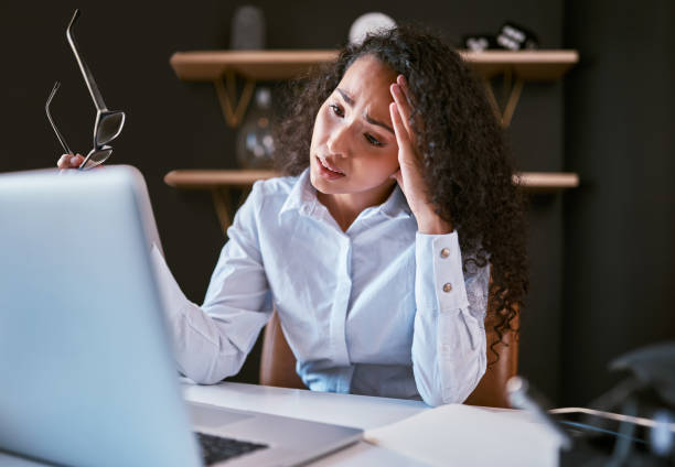 istock Young mixed race business woman feeling stressed while browsing the internet on a laptop in the office. Confused hispanic entrepreneur struggling while using a computer to work on her startup business 1396617305