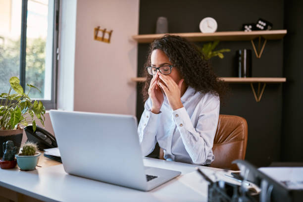 istock Young mixed race business woman feeling stressed and suffering from a headache while working on a startup in an office. Confused hispanic entrepreneur in pain with a migraine using a laptop to work 1396617308