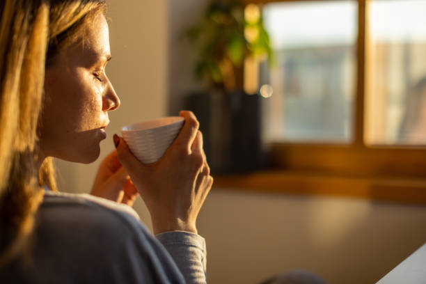 istock Young Caucasian woman drinking coffee 1396618216