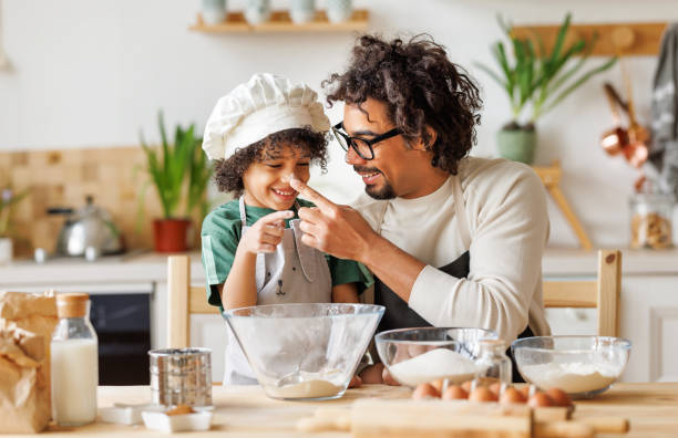 istock Cheerful black father and son cooking and having fun 1396618256