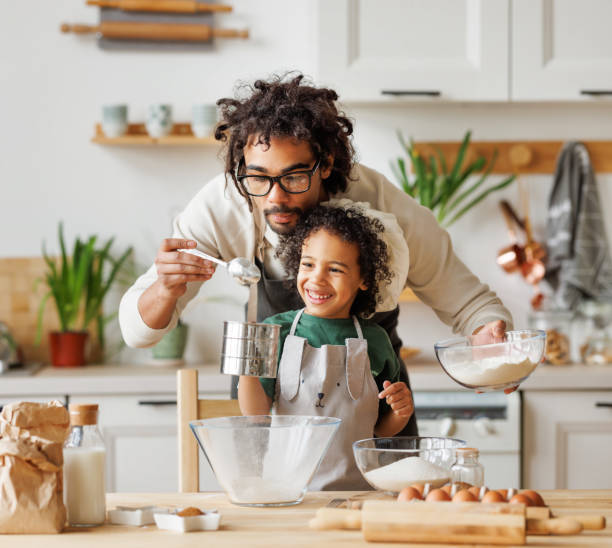 istock Black man and son cooking together in kitchen 1396618615