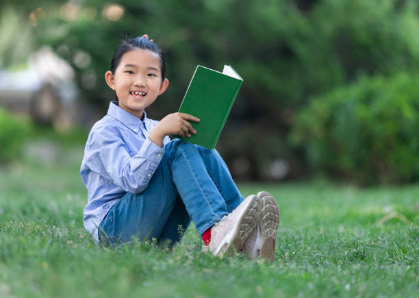 istock Little Girl Reading Book 1396619785