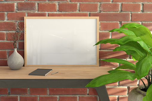 Horizontal wooden frame mock up on wooden desk and red brick wall. 3d render