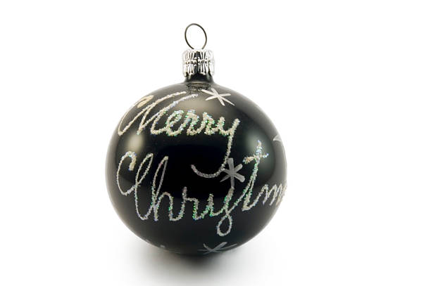 Merry christmas written on black glass ball stock photo