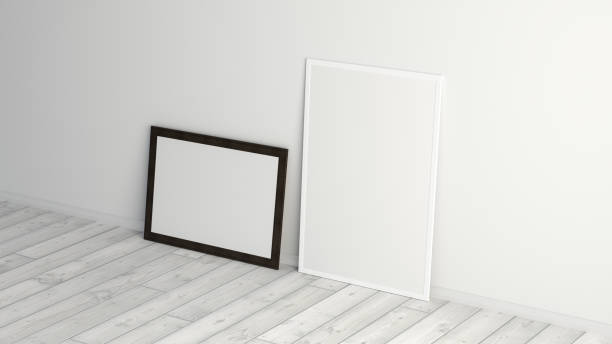 istock Mock up of horizontal and vertical black and white frames on the floor with white wall. 1396622483