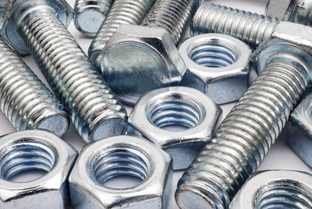 istock Scattered bolts and nuts on white background 1396623246