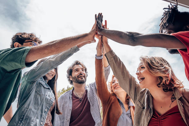istock young people giving high five - group of diverse multiethnic people make unity - collaboration team success concept. 1396624580