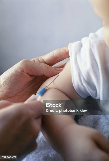 Meddle Entering A Babys Arm For Vaccination Stock Photo - Download Image Now - Baby - Human Age, Vaccination, Injecting