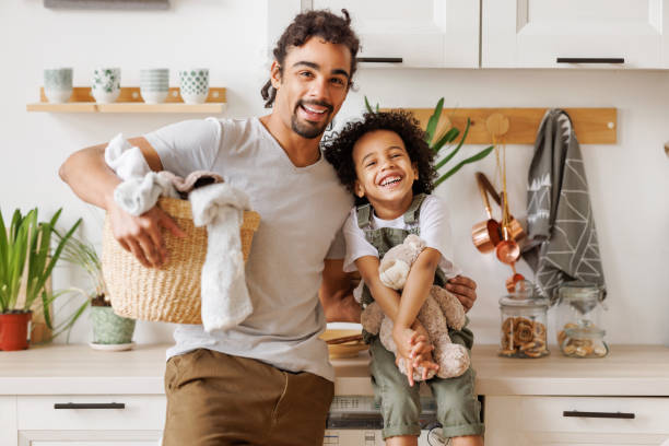 istock Happy father and son with laundry in kitchen 1396624997