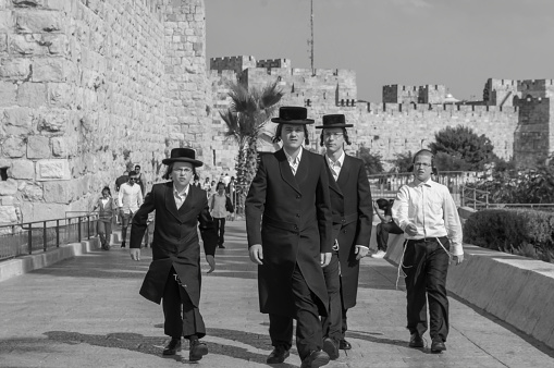 Jerusalem, Israel - June 2019: Ultra Orthodox religious Jewish in traditional clothing on the street of the old city of Jerusalem. Amazing black and white art photography