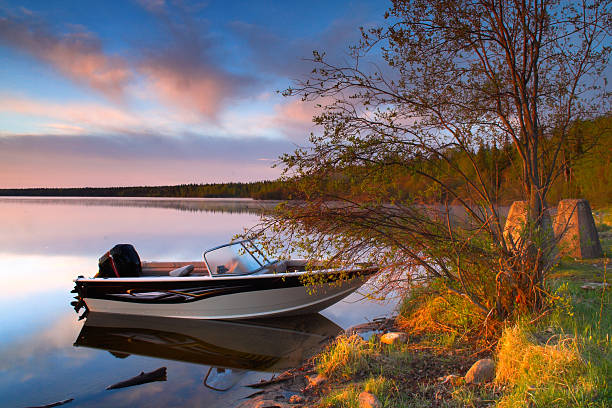 istock Small speed boat docked at the shoreline at sunset 139662676