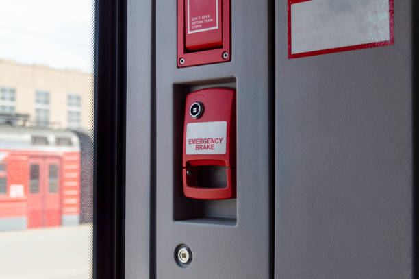 The Netherlands. March 31st, 2025:A close-up view of a red emergency stop button mounted on a yellow pole inside public transport. The clearly visible STOP label and tactile markings highlight passenger safety, accessibility, and emergency response systems in modern urban transit.