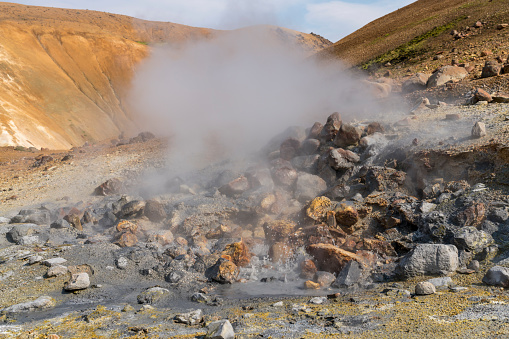 View on steaming at Hveradalir  geothermal area against blue sky on sunny day, Iceland