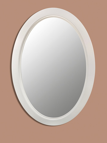 Mirror hanging on the pastel colored wall background with clipping path